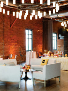 Industrial Columbus Ohio wedding venue featuring exposed brick, modern lighting, and a lounge-style cocktail setup