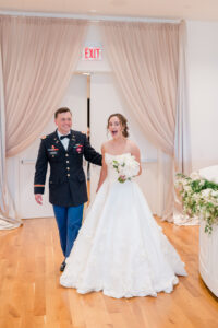 Bride and groom entering their wedding reception together after the ceremony