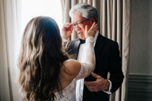Bride sharing an emotional moment with her father before the wedding ceremony