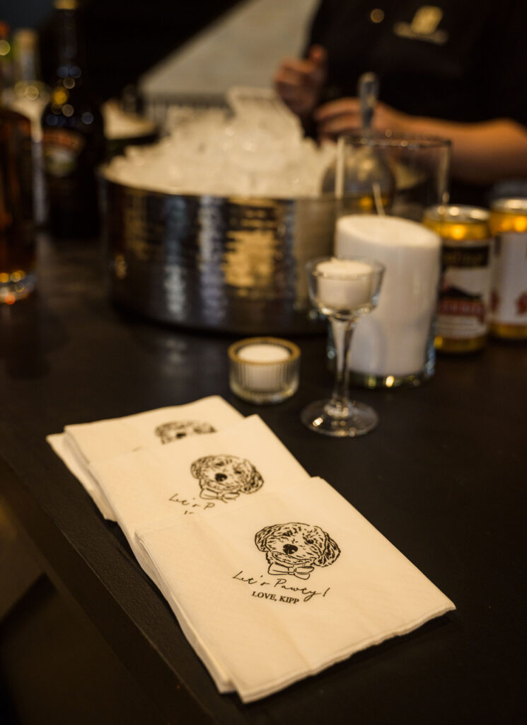 Custom wedding bar napkin featuring the couple’s pet illustration as part of a luxury Columbus, Ohio wedding reception design.