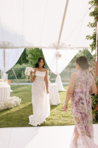Mother of the bride being honored during the wedding reception as guests look on emotionally