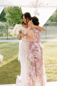 Mother of the bride being honored during the wedding reception as guests look on emotionally