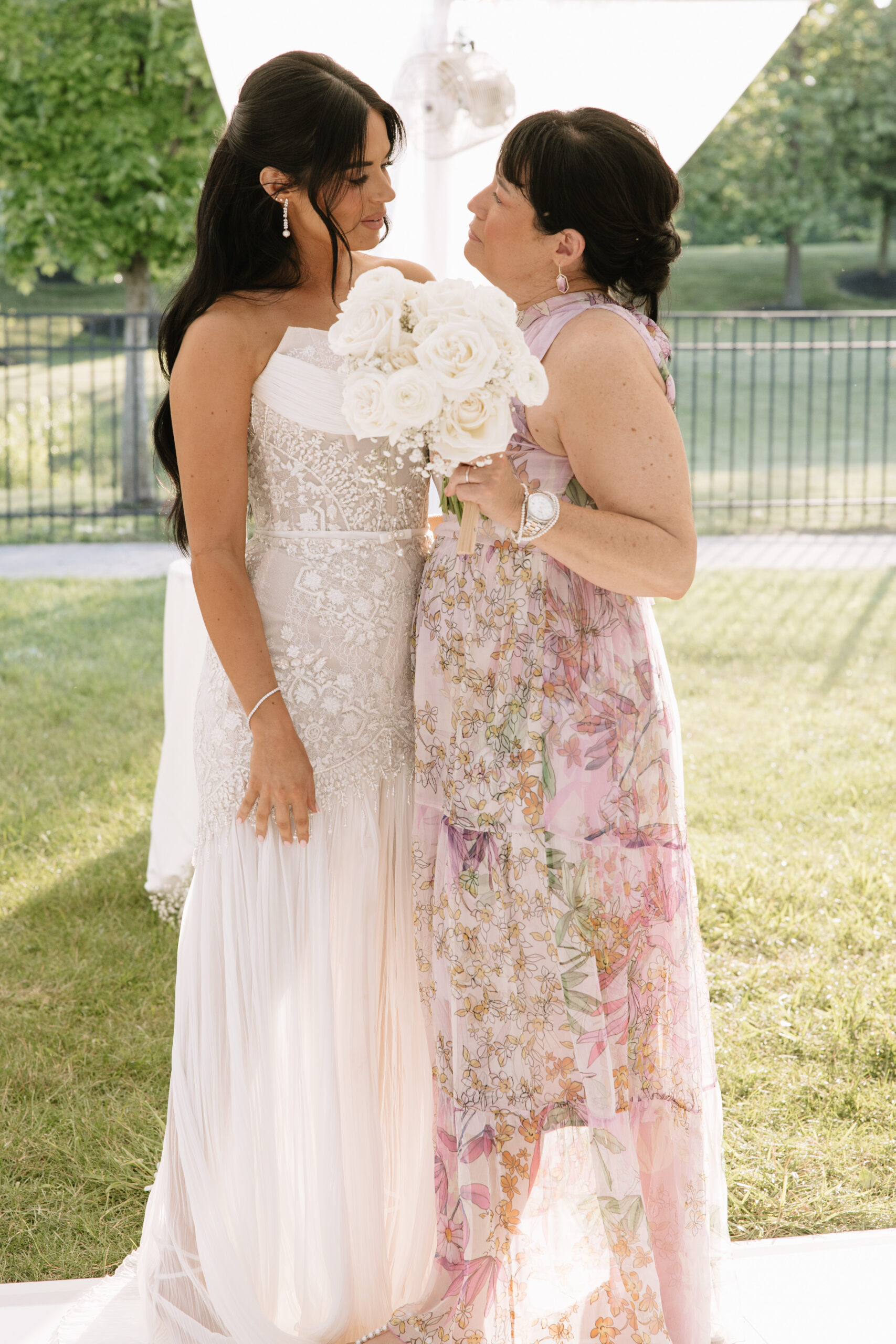 Mother of the bride being honored during the wedding reception as guests look on emotionally